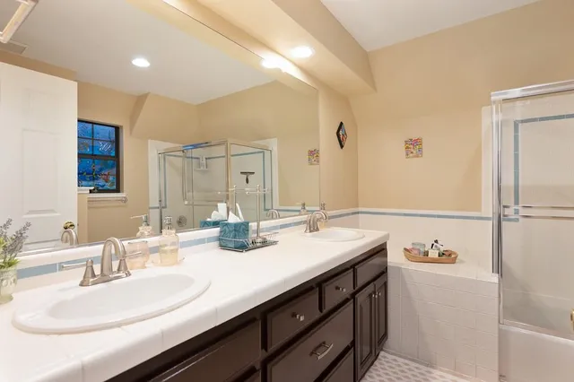 a front view of a house with a garden and trees