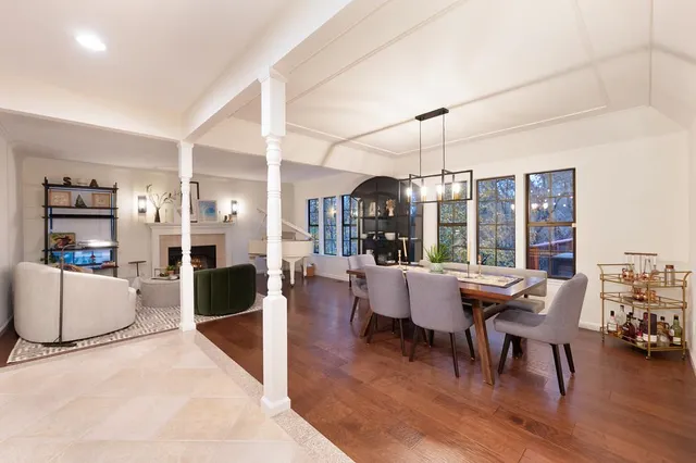 a dining room with furniture and wooden floor