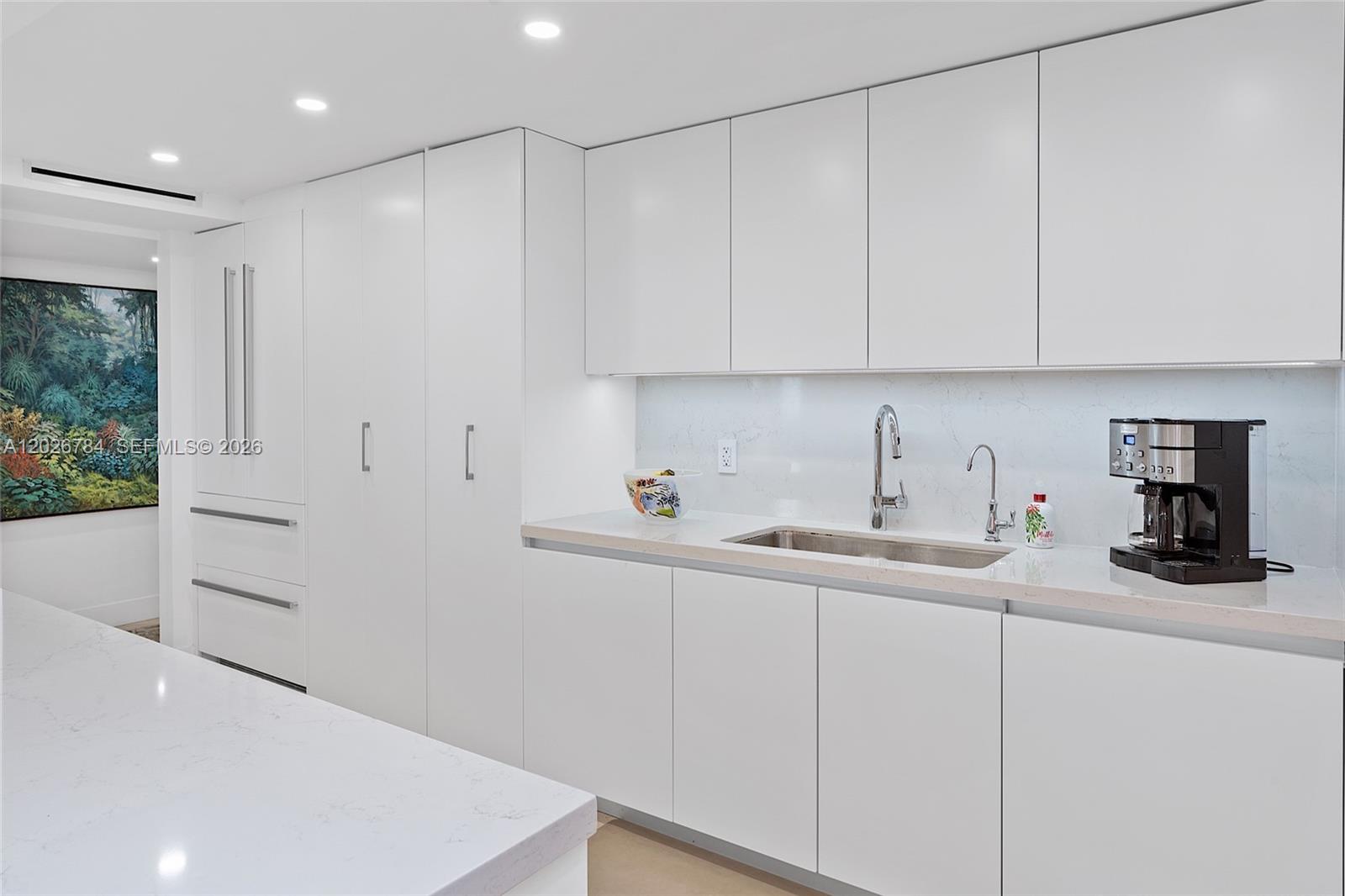 151 Southeast 15th Road, Unit 601 Miami, FL 33129 - Photo 14 of 36 a kitchen with a sink cabinets and window