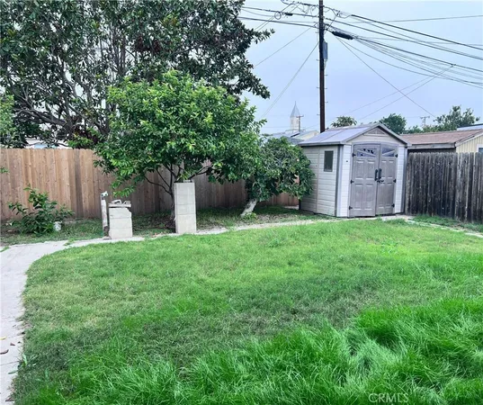 a view of a house with a yard and a tree