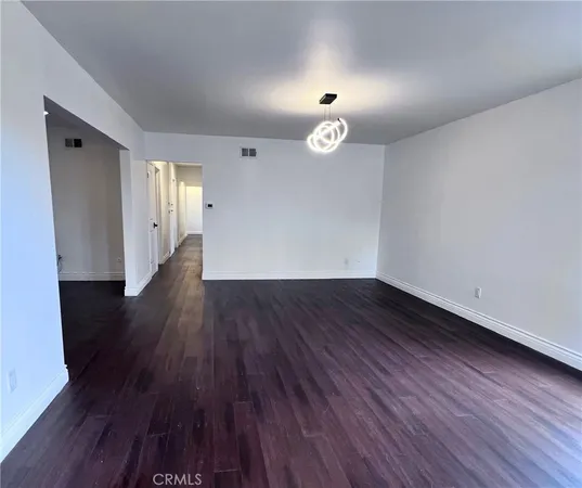 a view of a room with wooden floor and window