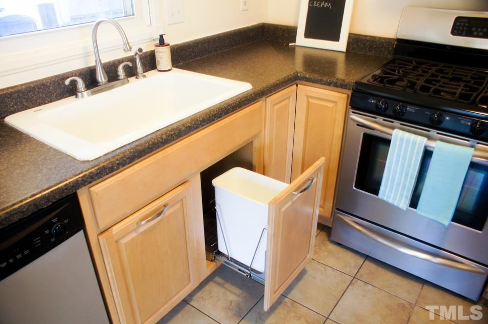 1505 Euclid Road Durham, NC 27713 - Photo 9 of 25 Just showing 1 pull-out, and the cupboard to it's left has a trash/recycle can too!
