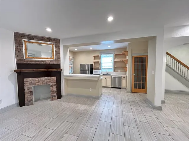 a view of a kitchen with furniture and a fireplace