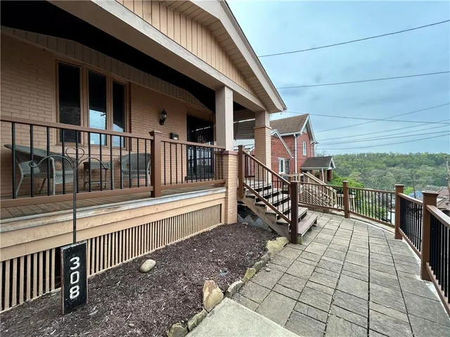 a view of a roof deck with couches and wooden floor