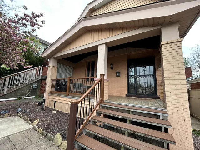 a front view of a house with entryway and stairs