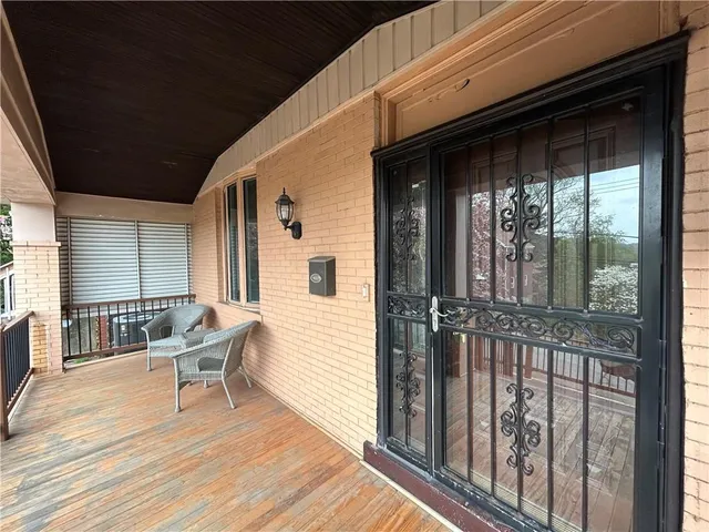 a balcony with table and chairs