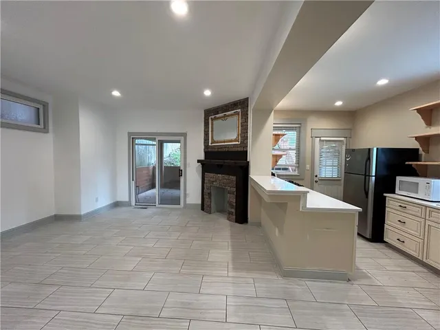 a living room with fireplace furniture and a flat screen tv