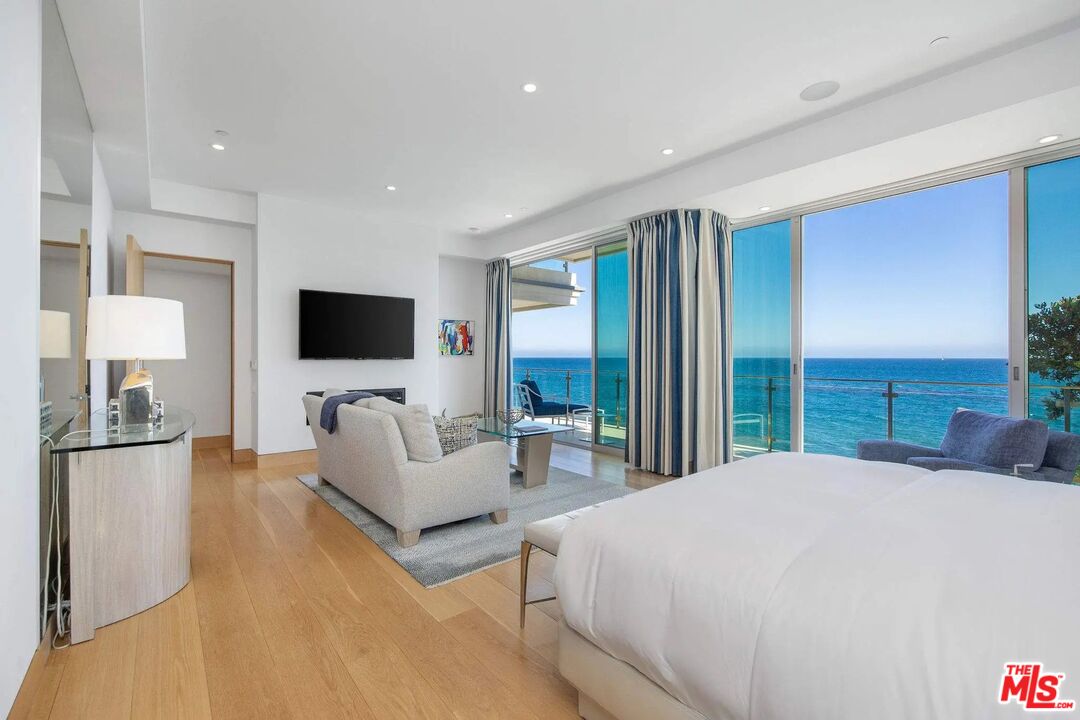 24380 Malibu Road Malibu, CA 90265 - Photo 23 of 48 a bedroom with a bed television and a large window