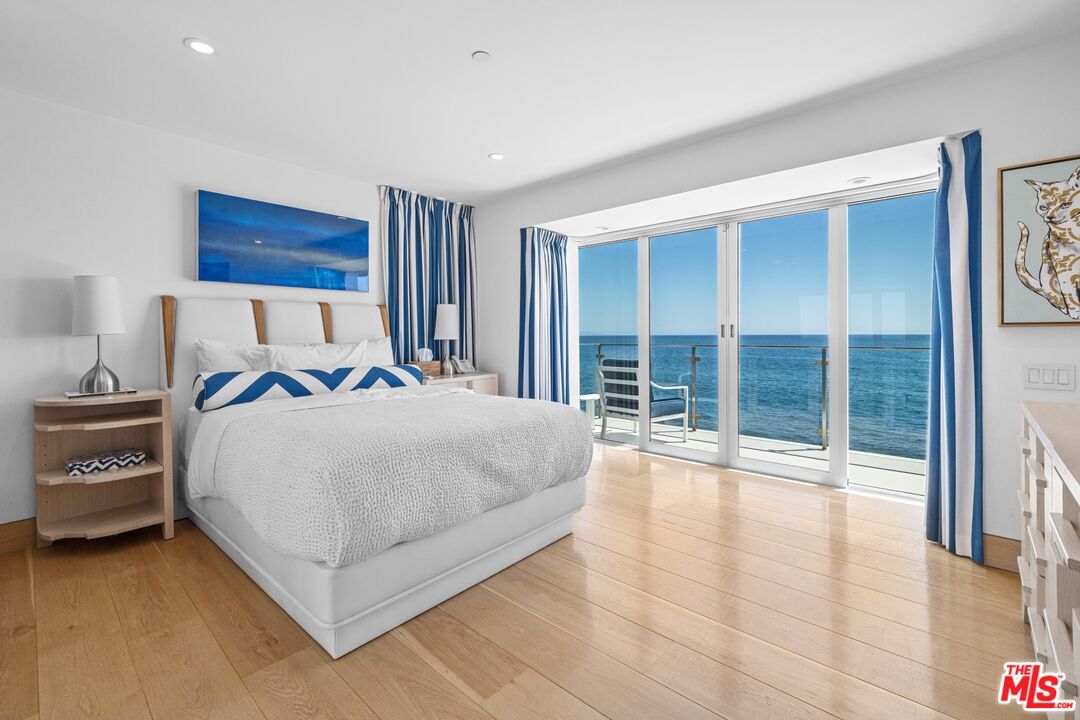 24380 Malibu Road Malibu, CA 90265 - Photo 28 of 48 a large bedroom with a bed and a large window
