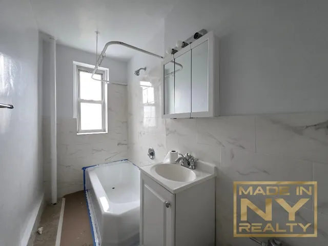 a bathroom with a sink and mirror with toilet