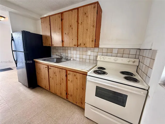 a kitchen with a stove microwave and refrigerator