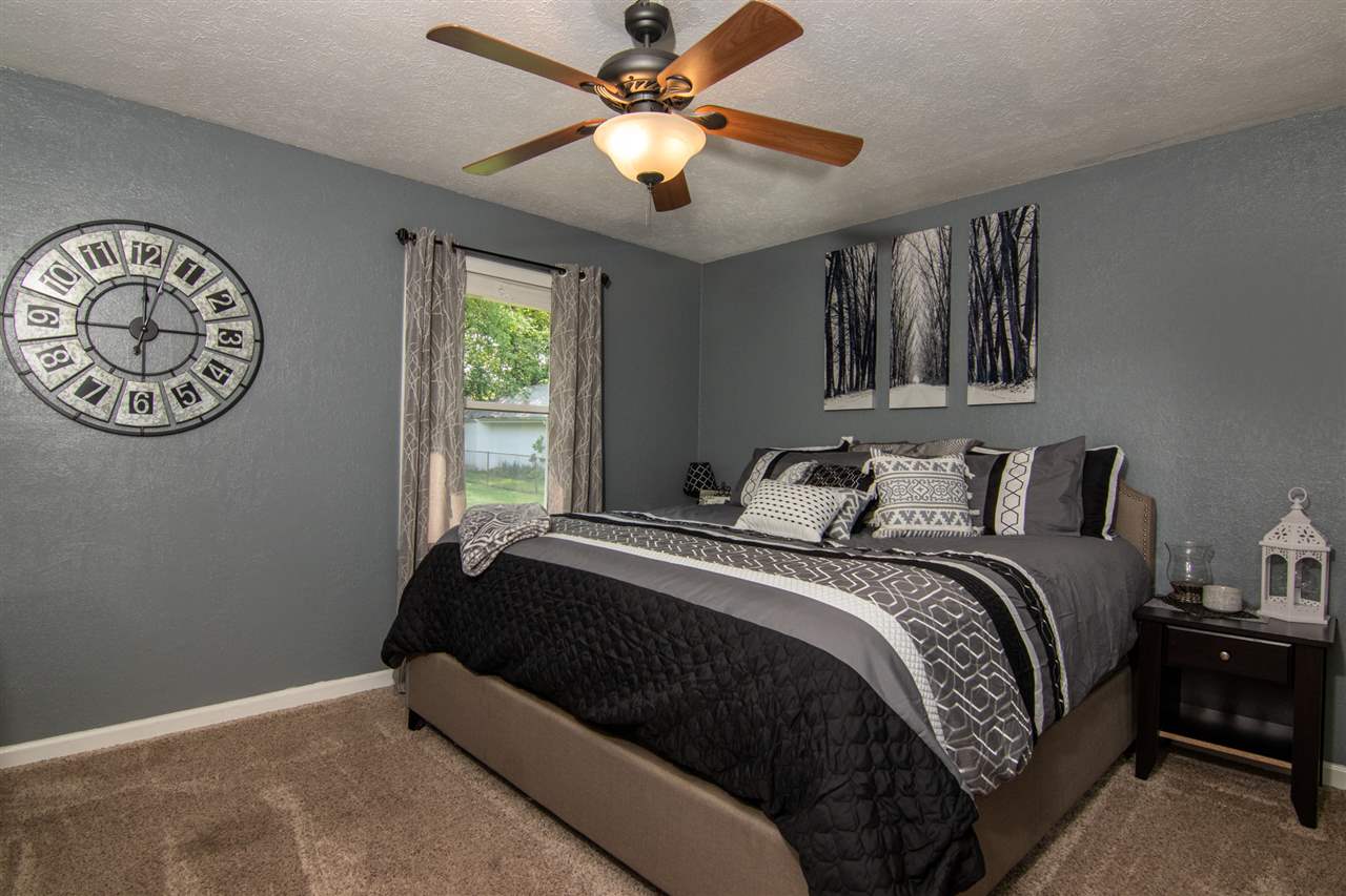 5780 Rural Edge Drive Roscoe, IL 61073 - Photo 11 of 25 a bedroom with a bed and a chandelier
