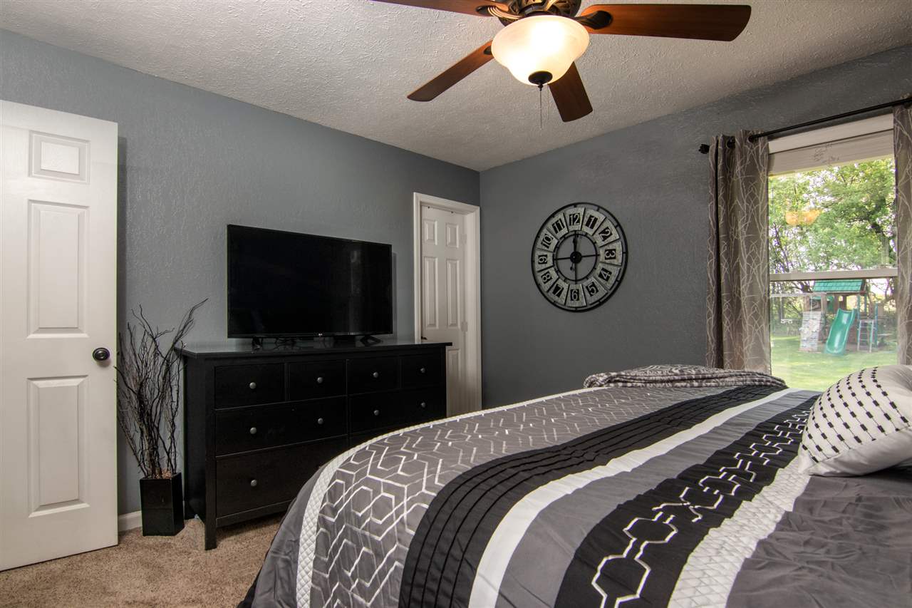 5780 Rural Edge Drive Roscoe, IL 61073 - Photo 12 of 25 a bedroom with a bed and a flat tv screen on dresser