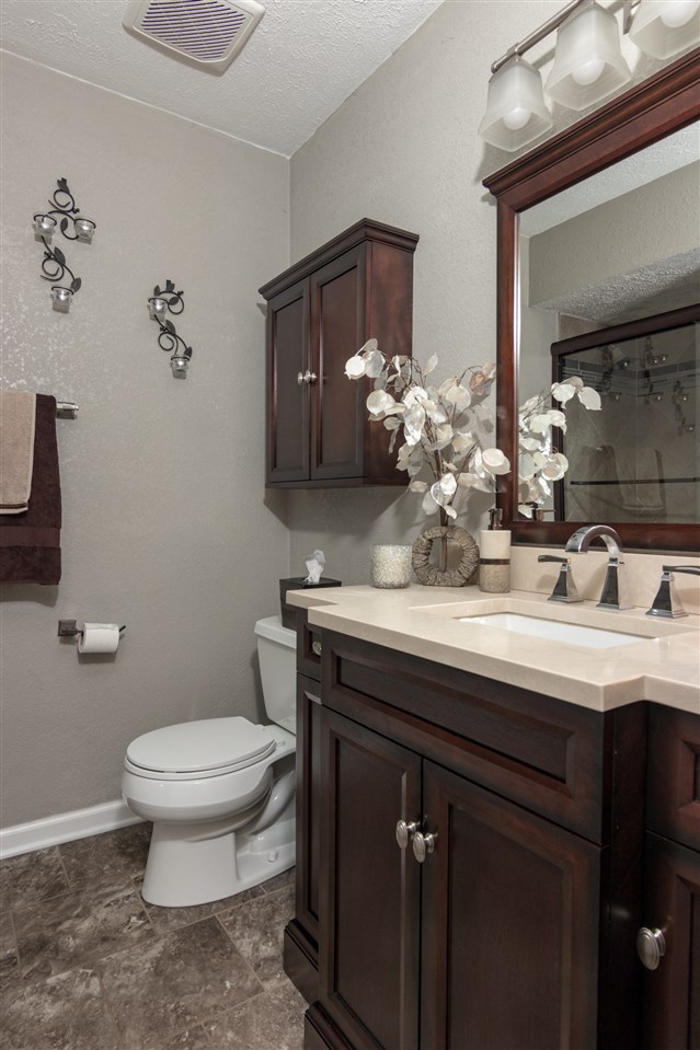 5780 Rural Edge Drive Roscoe, IL 61073 - Photo 16 of 25 a bathroom with a granite countertop sink a toilet and a mirror