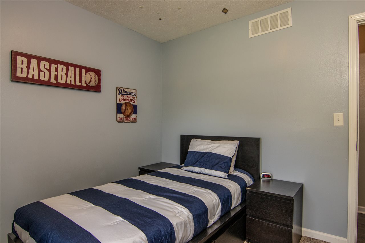 5780 Rural Edge Drive Roscoe, IL 61073 - Photo 20 of 25 a bedroom with a bed and a lamp on dresser
