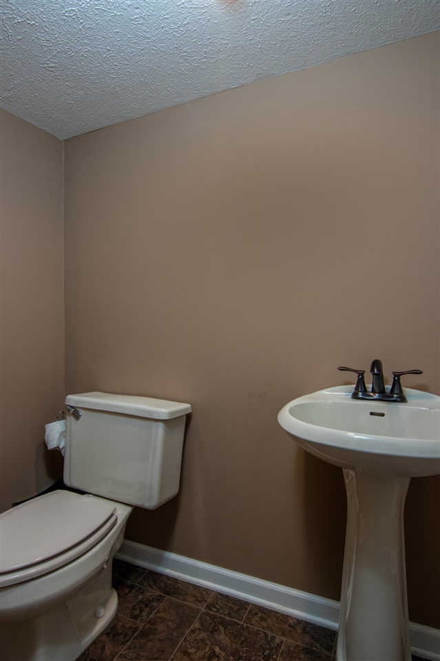 5780 Rural Edge Drive Roscoe, IL 61073 - Photo 21 of 25 a white toilet sitting next to a bathroom sink