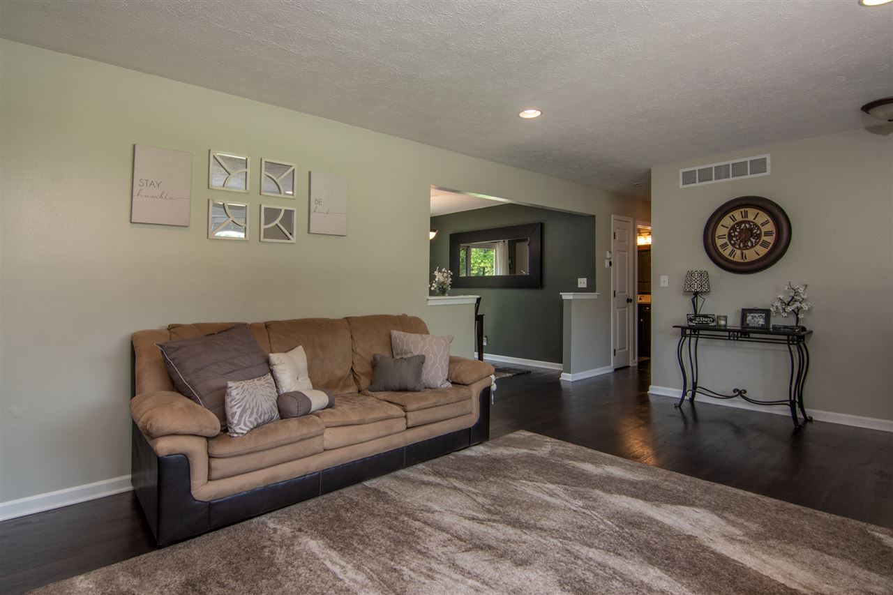 5780 Rural Edge Drive Roscoe, IL 61073 - Photo 6 of 25 a living room with furniture a clock on wall and a table
