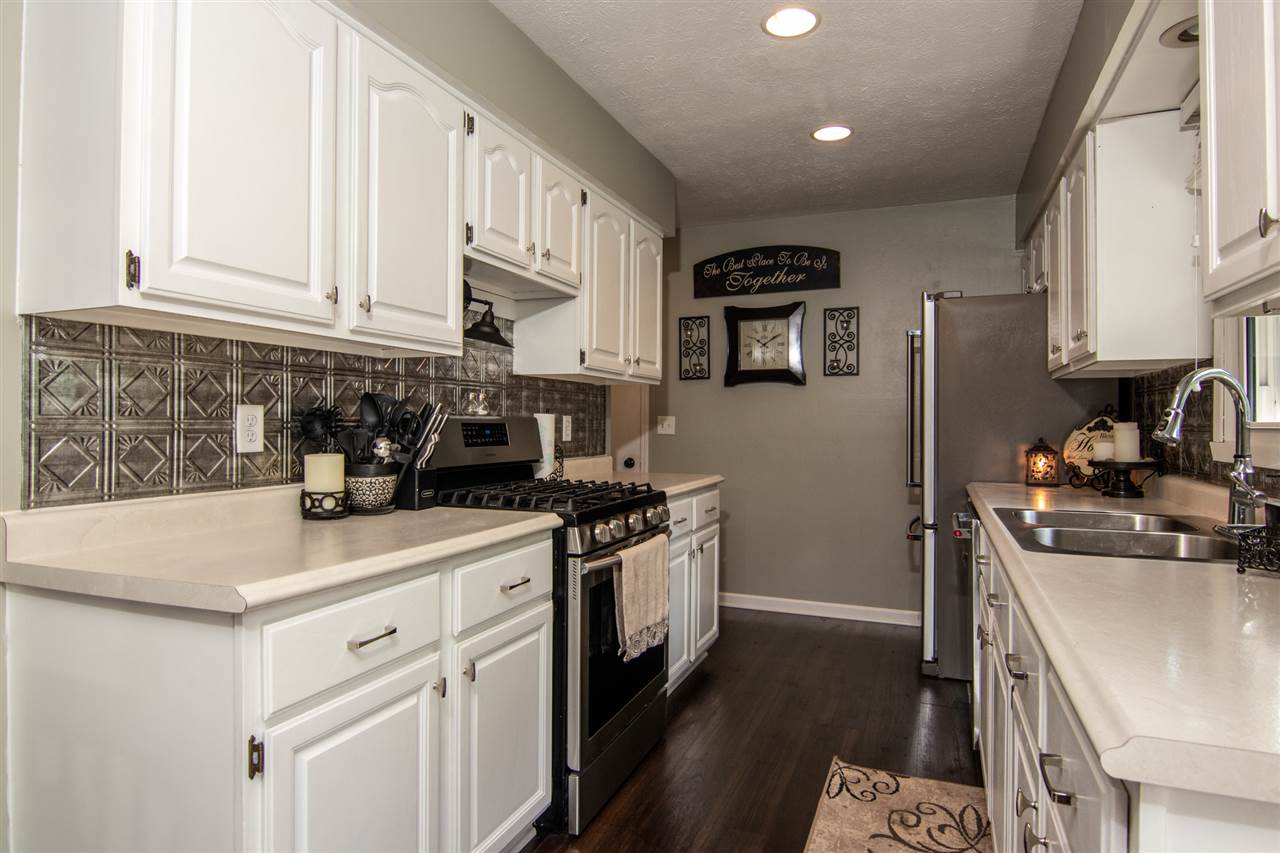 5780 Rural Edge Drive Roscoe, IL 61073 - Photo 10 of 25 a kitchen with stainless steel appliances granite countertop a sink stove and refrigerator
