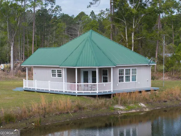 a aerial view of a house with a yard