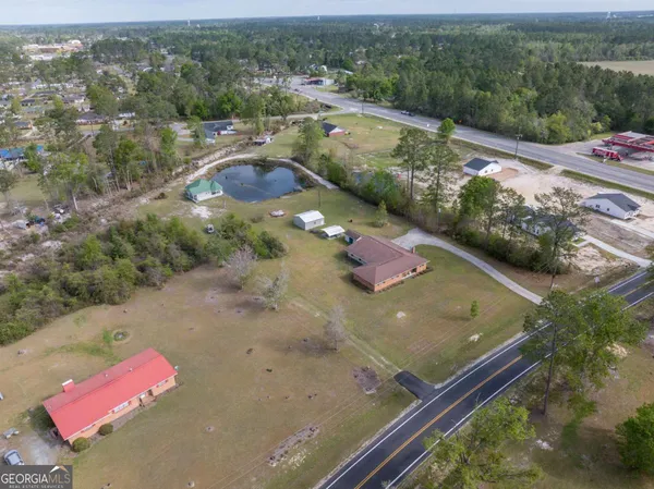 an aerial view of a house with a yard