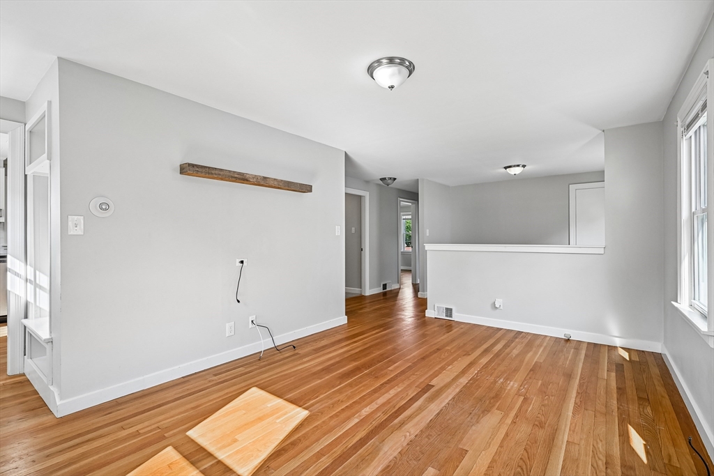42 East Main Street Gloucester, MA 01930 - Photo 8 of 25 a view of an empty room with wooden floor and a window