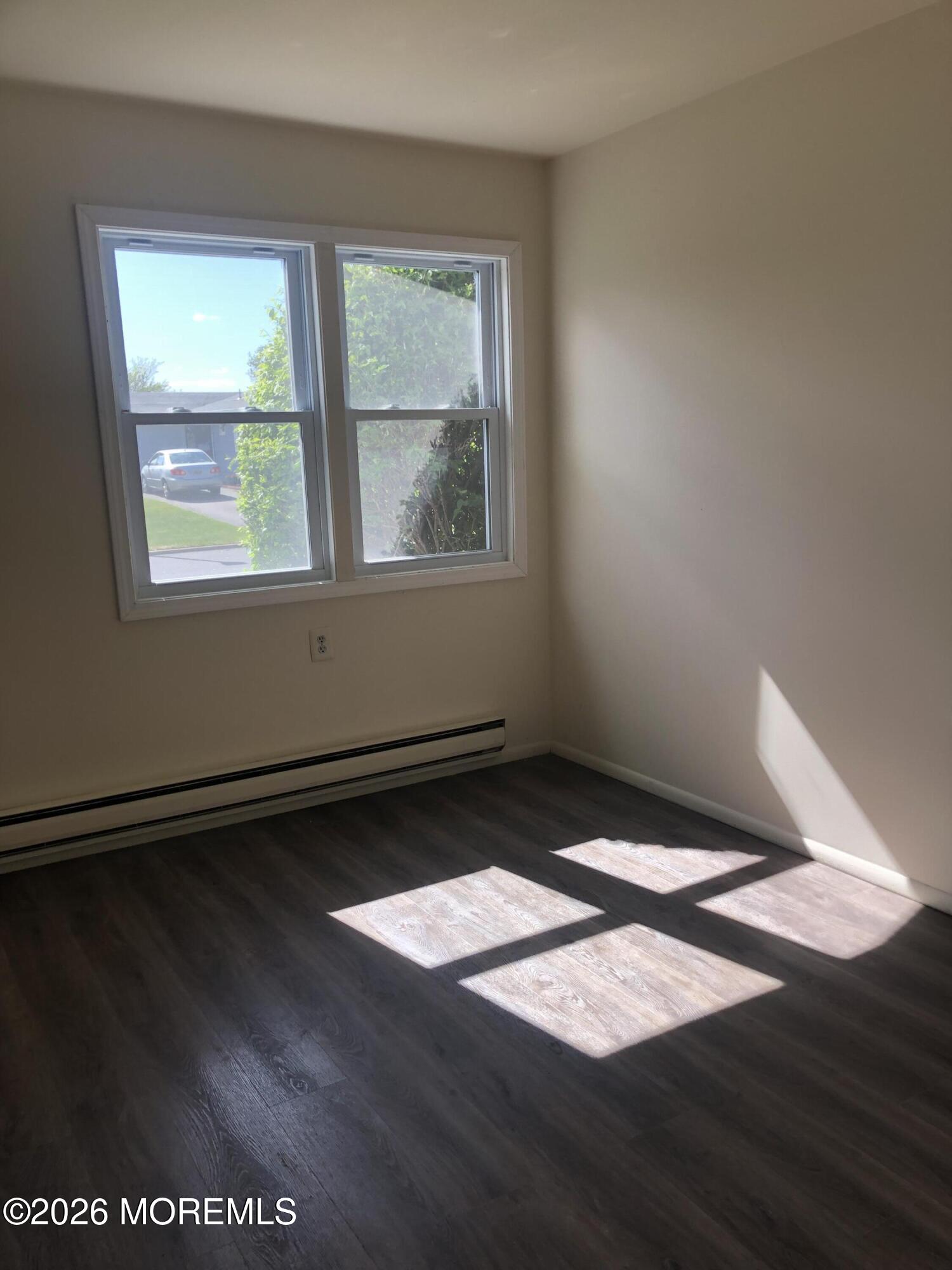 6 Dickinson Road Brick, NJ 08724 - Photo 11 of 17 an empty room with wooden floor and windows