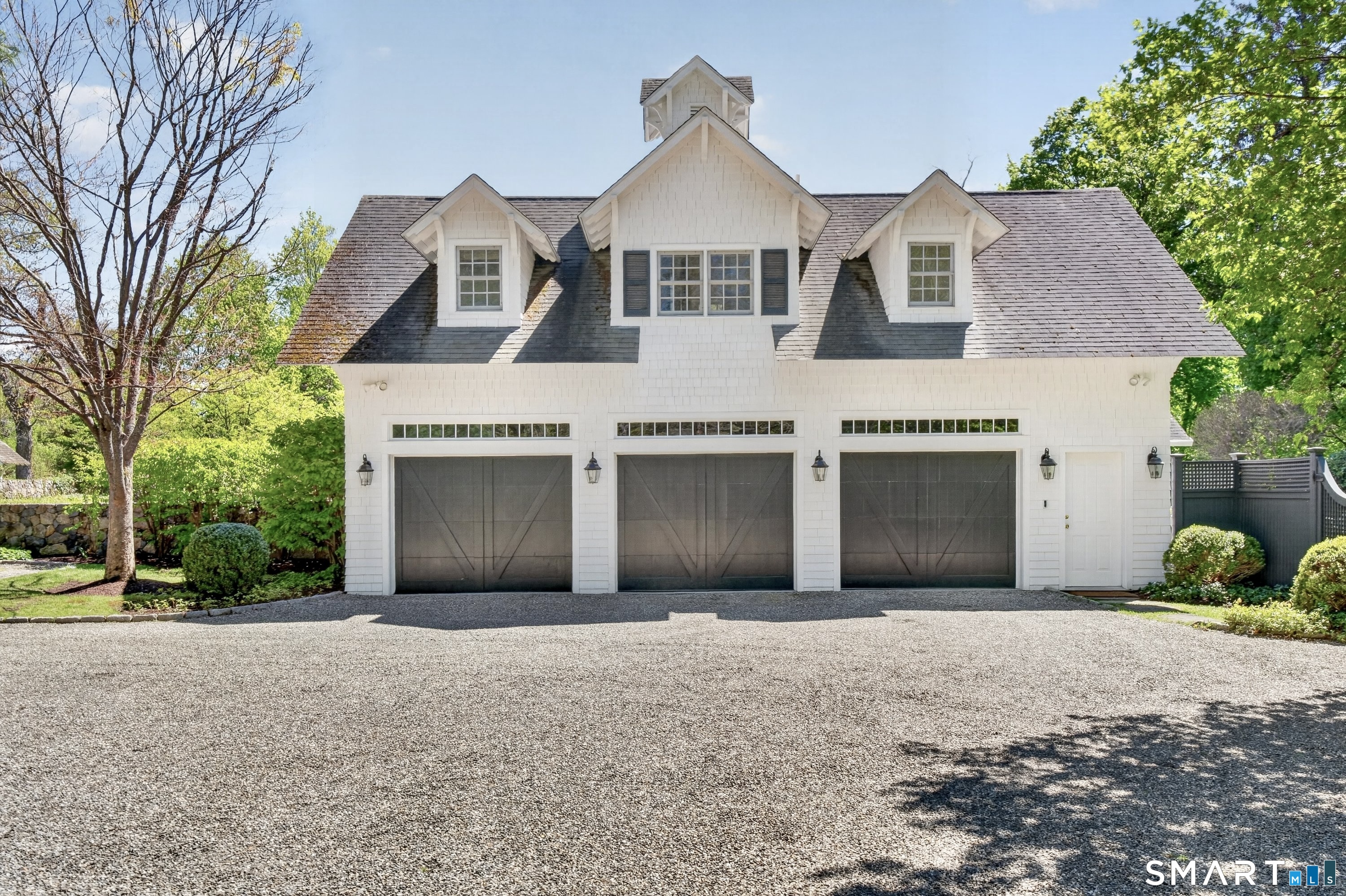 41 Peaceable Street Ridgefield, CT 06877 - Photo 38 of 40 a front view of a house with a yard and garage