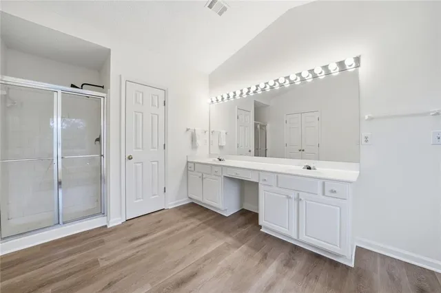 a bathroom with a double vanity sink and mirror