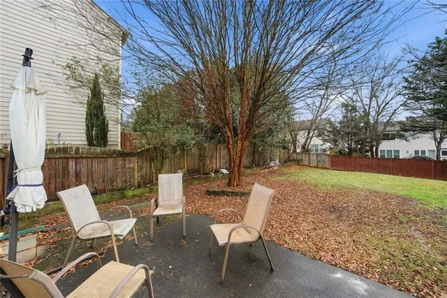 a view of backyard with seating and green space