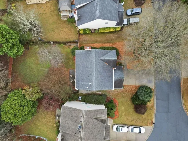 an aerial view of a house with a yard