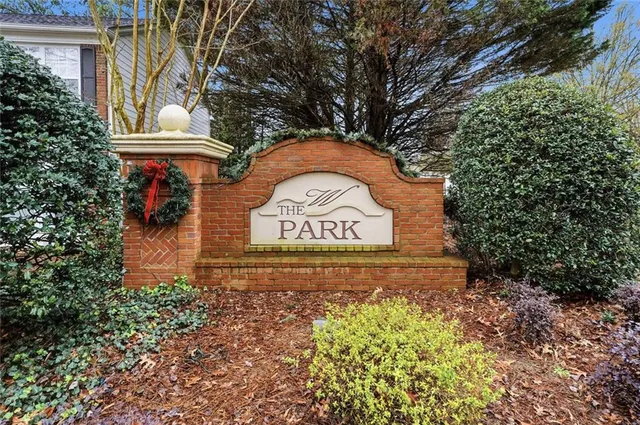 a sign that is sitting in front of flowers