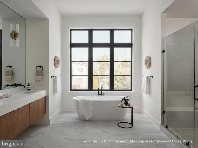 a bathroom with a tub sink and mirror