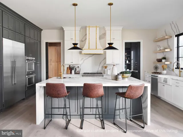 a kitchen with granite countertop a table chairs stove and refrigerator