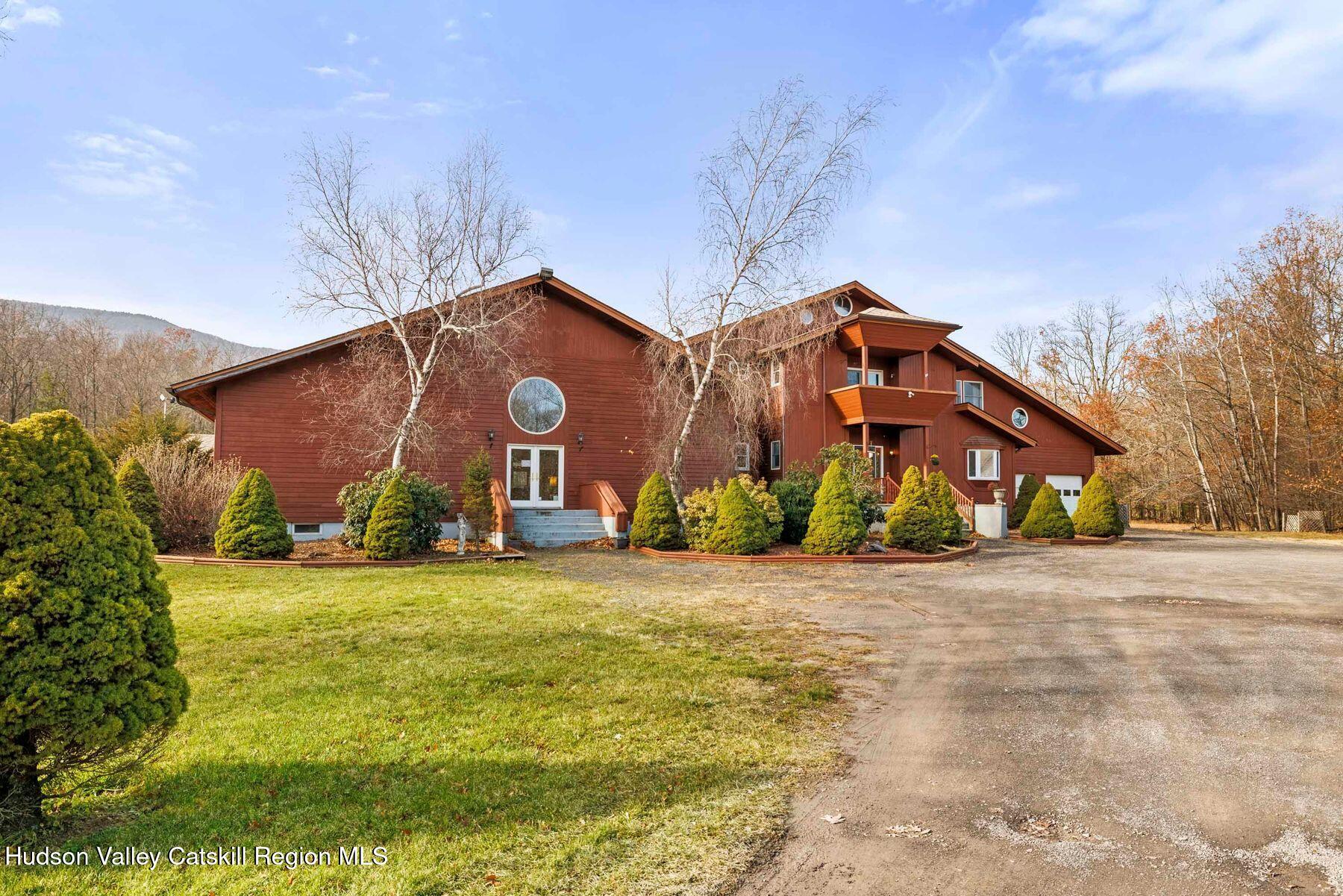 404 Winter Clove Road Round Top, NY 12473 - Photo 103 of 133 a front view of house with yard and trees in the background