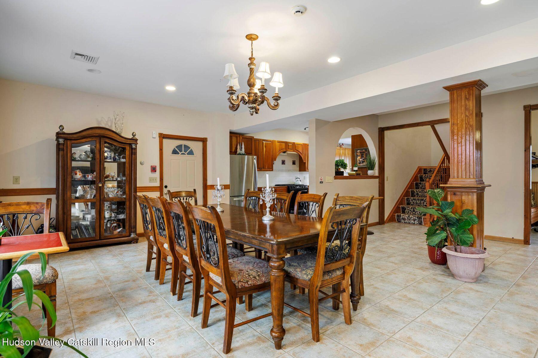 404 Winter Clove Road Round Top, NY 12473 - Photo 13 of 133 a view of a dining room with furniture and a chandelier