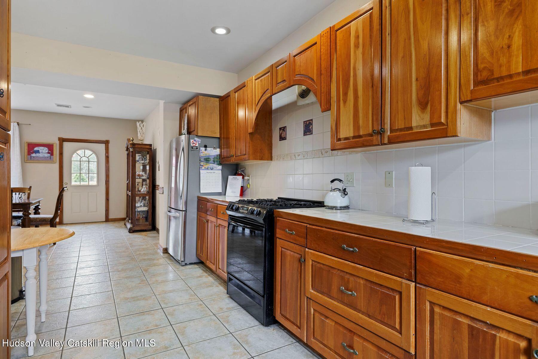 404 Winter Clove Road Round Top, NY 12473 - Photo 16 of 133 a kitchen with stainless steel appliances granite countertop a refrigerator and a stove top oven