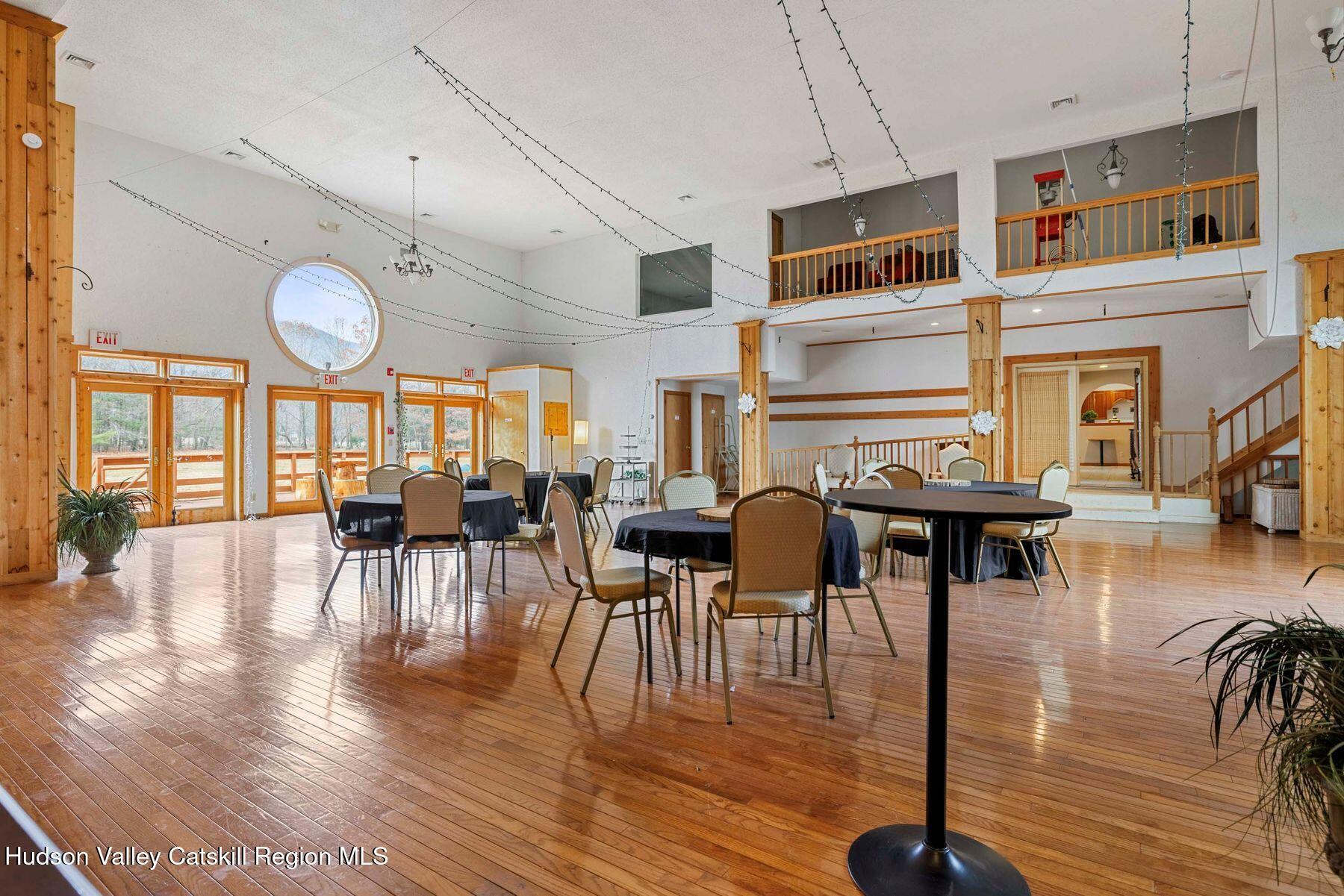 404 Winter Clove Road Round Top, NY 12473 - Photo 30 of 133 a living room with lots of furniture a wooden floor and a large window