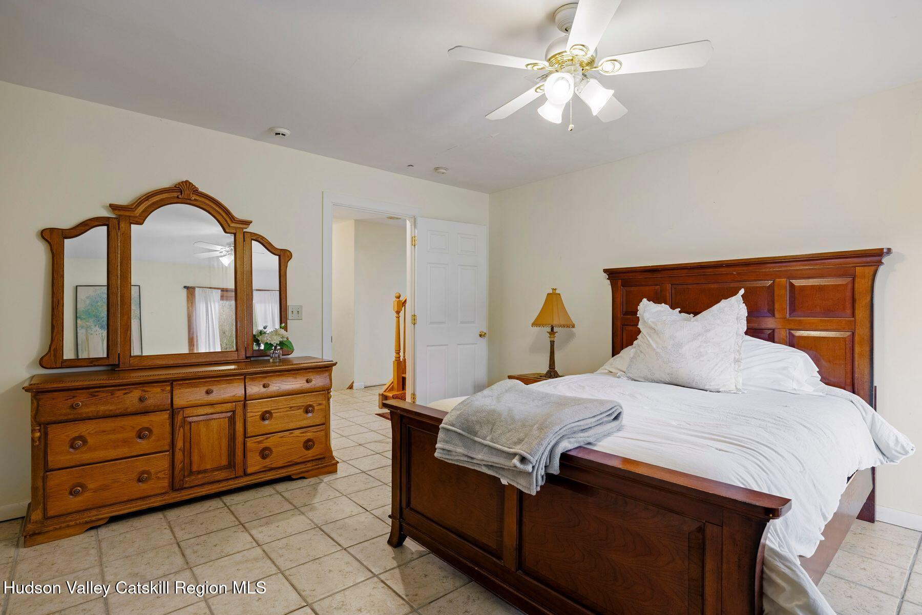 404 Winter Clove Road Round Top, NY 12473 - Photo 31 of 133 a bedroom with a large bed and a chandelier