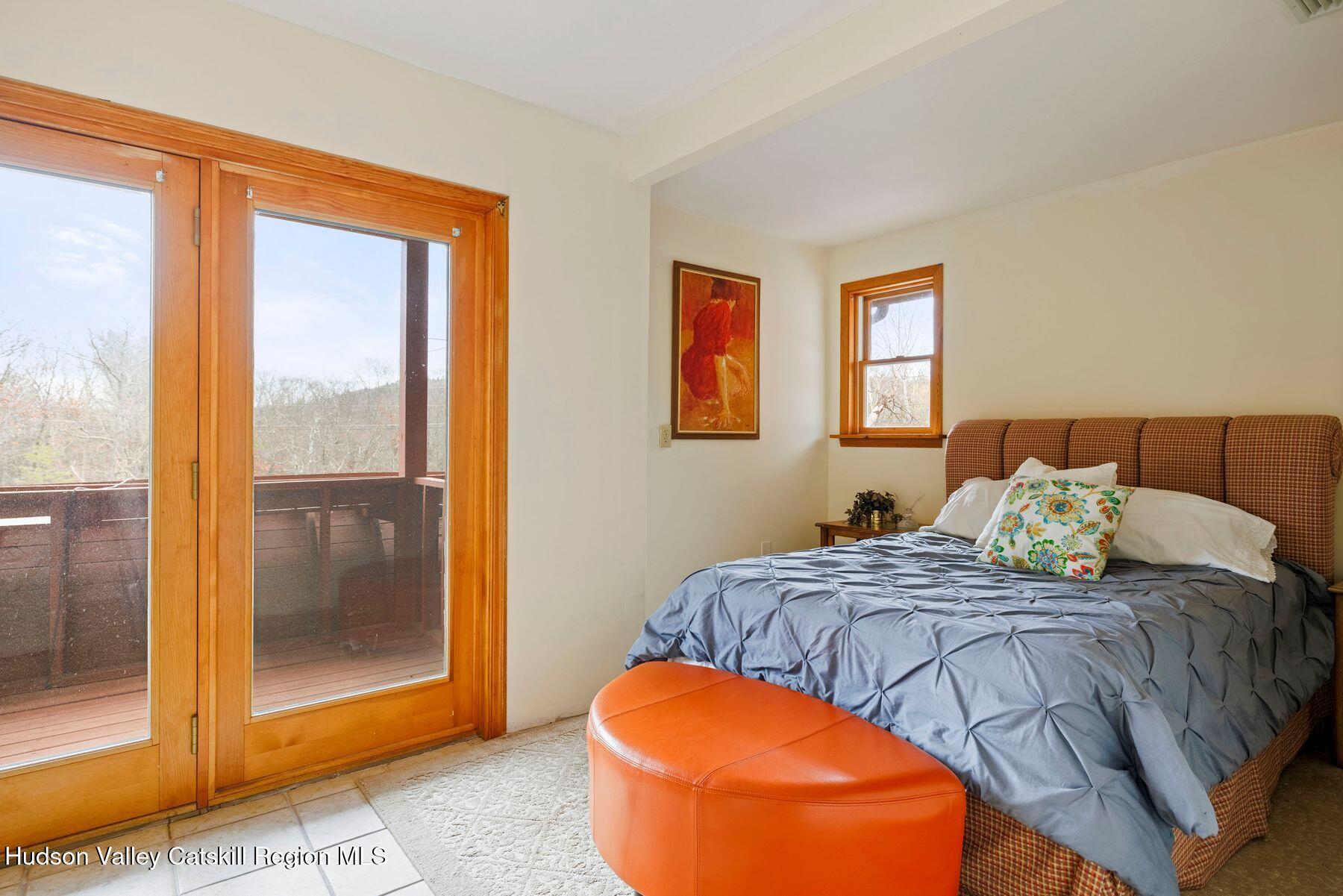 404 Winter Clove Road Round Top, NY 12473 - Photo 44 of 133 a bedroom with bed and glass door