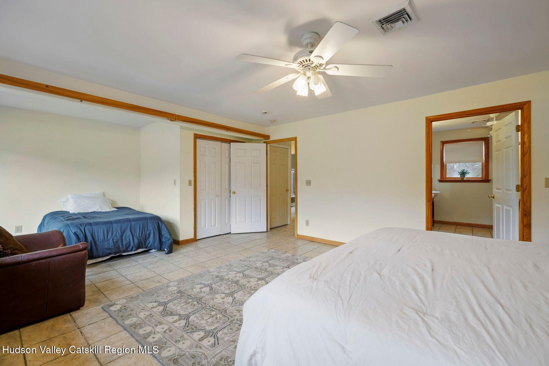 404 Winter Clove Road Round Top, NY 12473 - Photo 50 of 133 a bedroom with a large bed and a chandelier