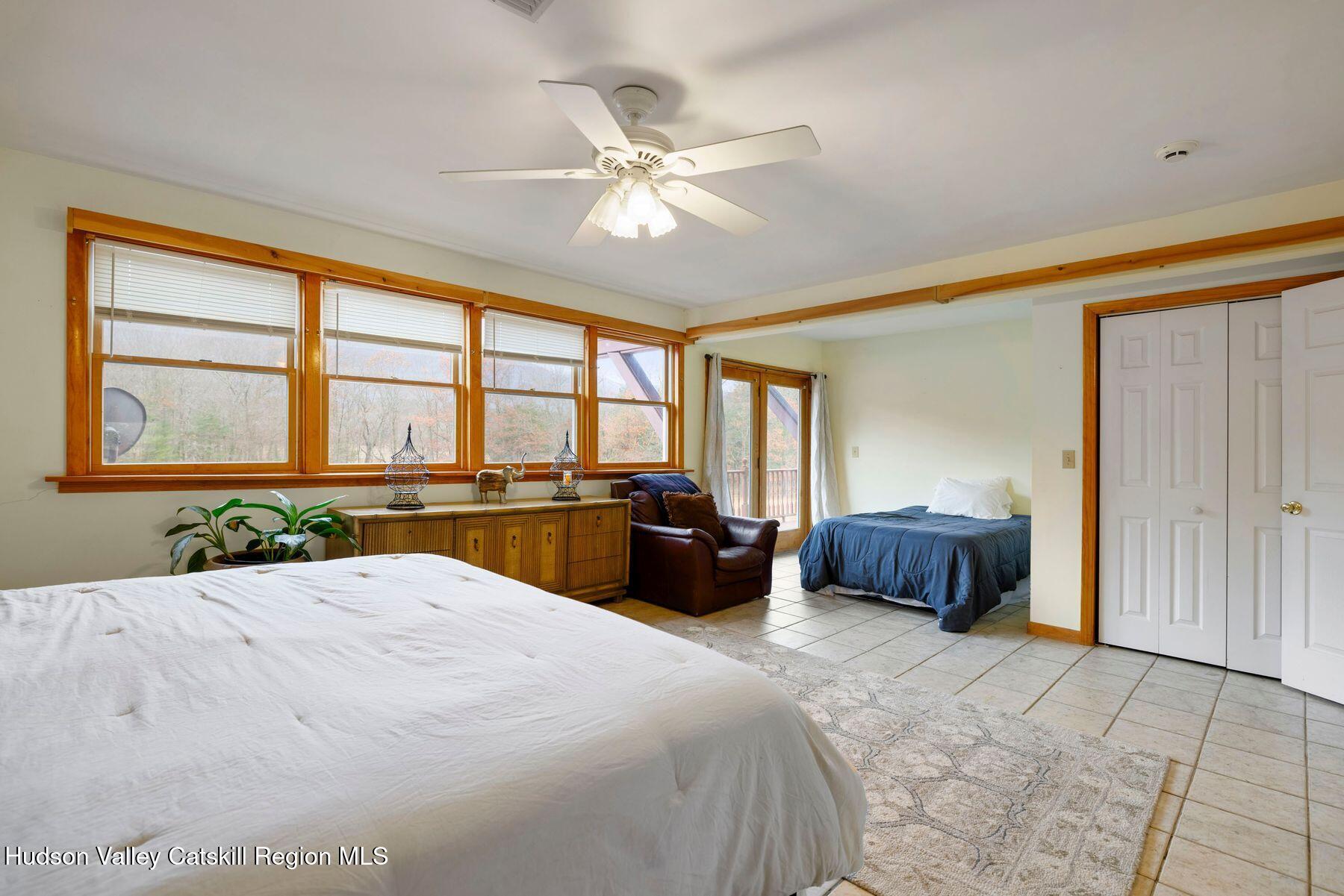 404 Winter Clove Road Round Top, NY 12473 - Photo 51 of 133 a bedroom with a large bed and a large window