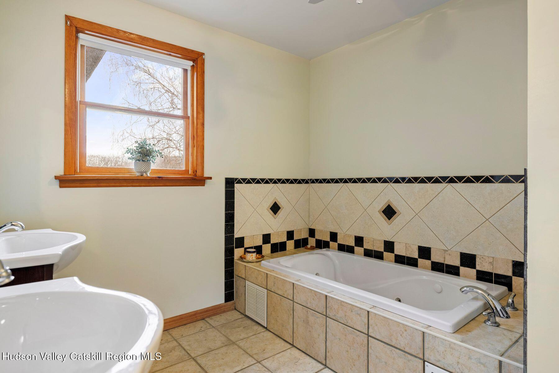 404 Winter Clove Road Round Top, NY 12473 - Photo 53 of 133 a bathroom with a tub sink and mirror