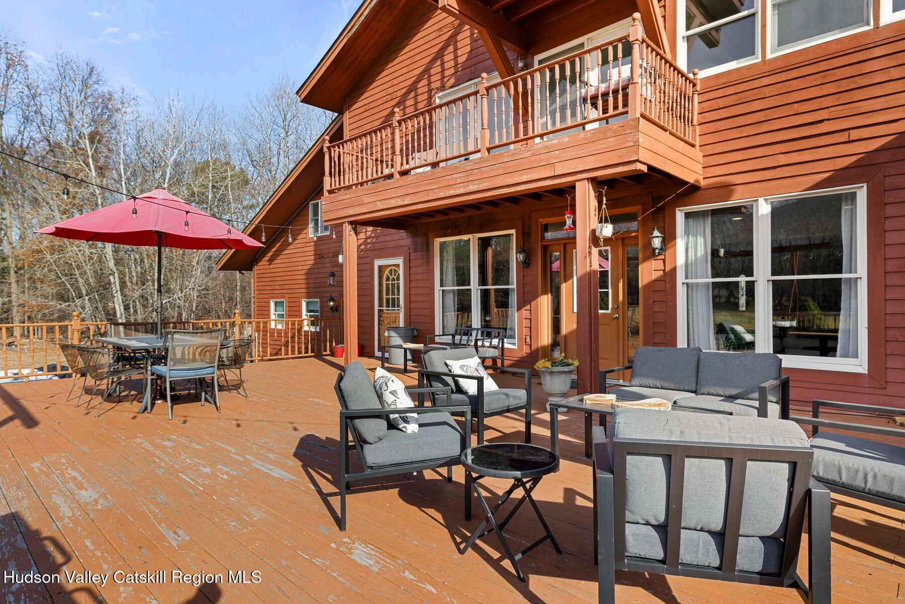 404 Winter Clove Road Round Top, NY 12473 - Photo 89 of 133 a view of a patio with table and chairs under an umbrella