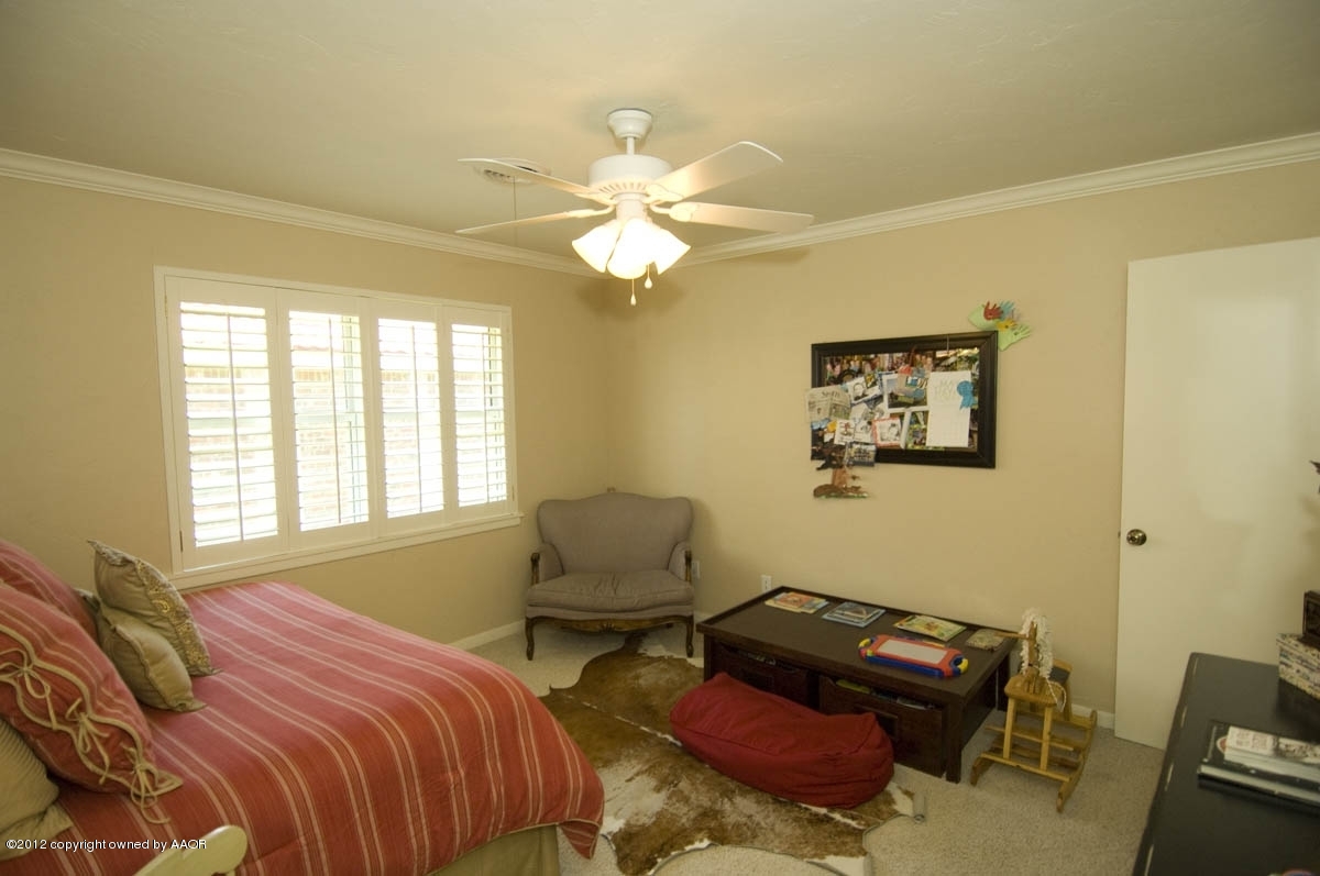 6205 Jameson Road Amarillo, TX 79106 - Photo 22 of 36 a bedroom with a bed and wooden furniture