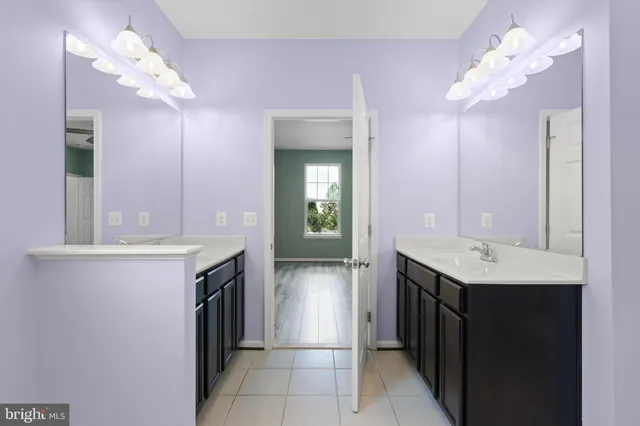 a bathroom with a sink a vanity and a mirror