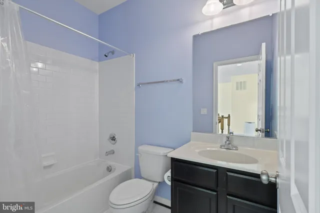 a bathroom with a sink toilet a mirror and shower