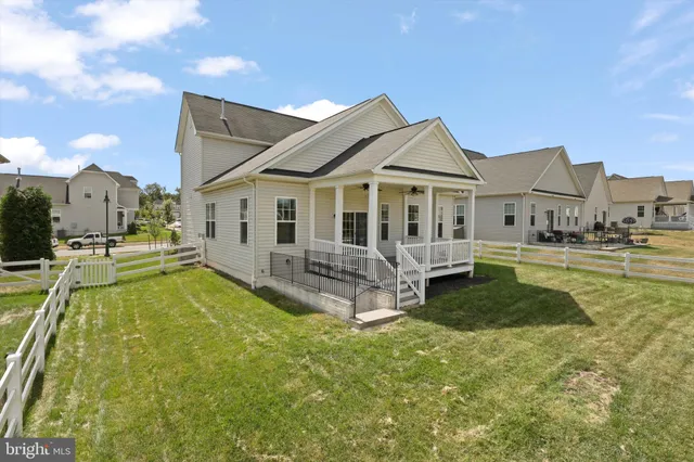 a view of a house with a big yard and sitting area