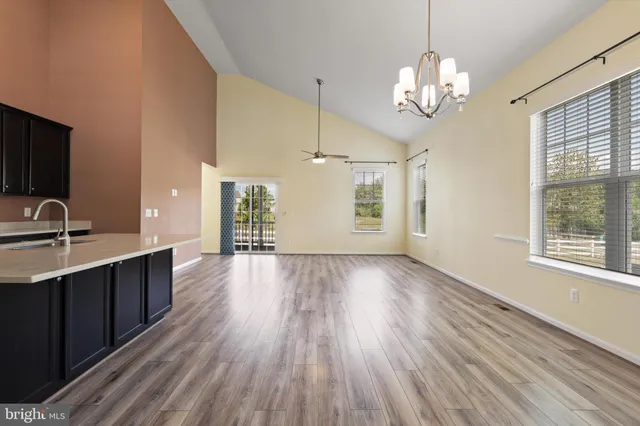a view of a kitchen counter space a sink and wooden floor