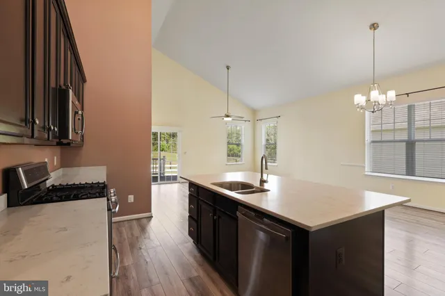 a kitchen with sink cabinets and wooden floor