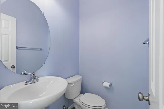a white toilet sitting next to a bathroom sink